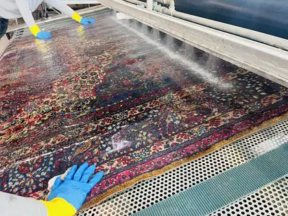 Tapis noué main en cours de lavage à la main dans l&rsquo;atelier Tissu Ébène